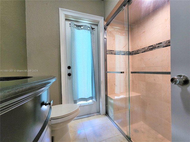 bathroom with vanity, an enclosed shower, toilet, and tile patterned floors