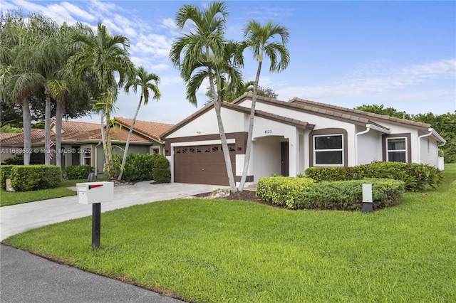 view of front of property featuring a garage and a front lawn