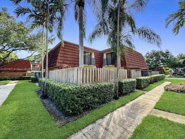 view of side of home featuring a lawn