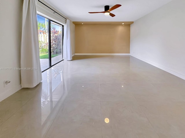 tiled empty room with ceiling fan