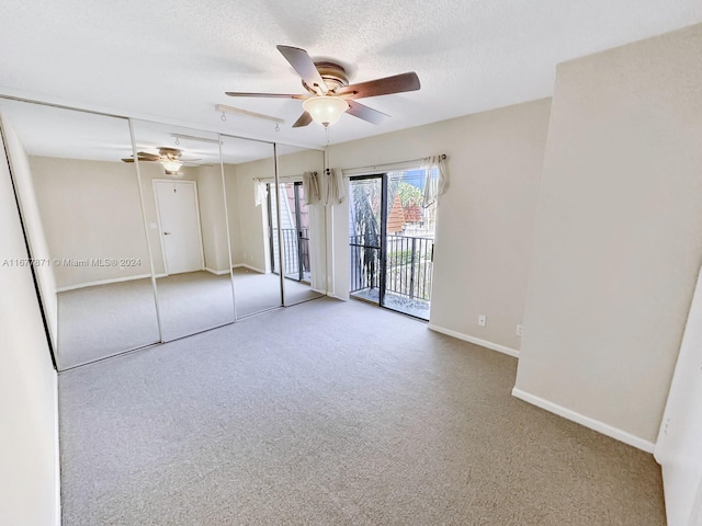 unfurnished bedroom with access to exterior, carpet floors, a closet, a textured ceiling, and ceiling fan