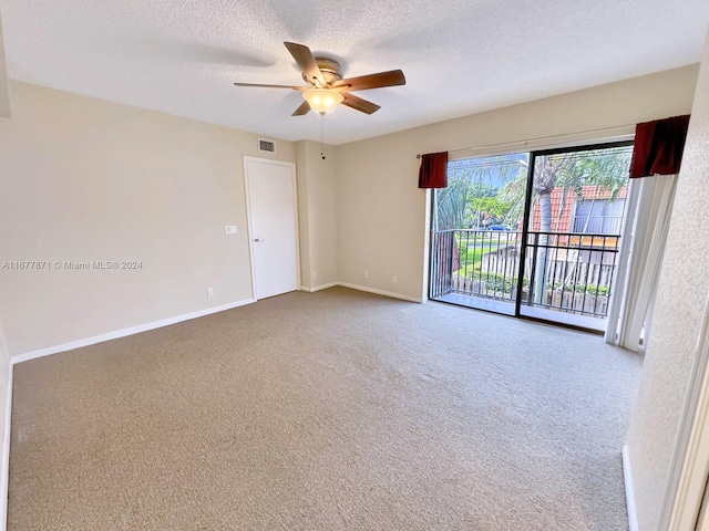 carpeted empty room with a textured ceiling and ceiling fan