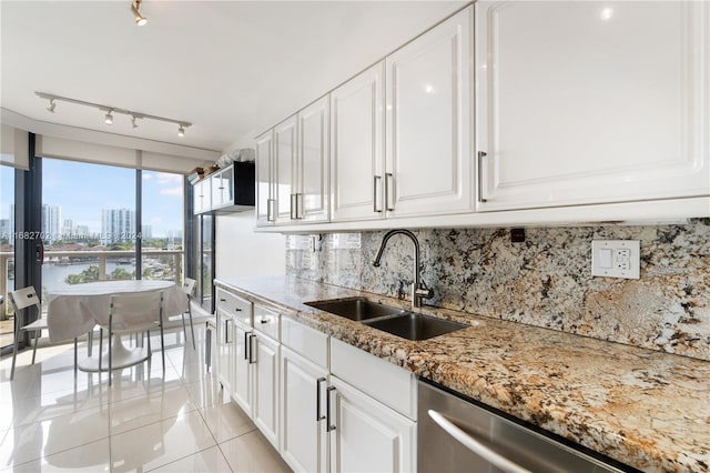 kitchen featuring dishwasher, light tile patterned flooring, sink, white cabinets, and track lighting