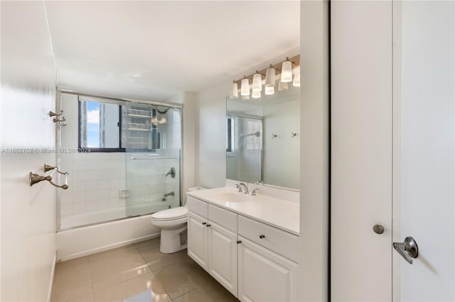 full bathroom featuring vanity, toilet, enclosed tub / shower combo, and tile patterned flooring