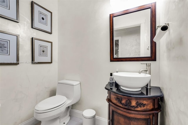 bathroom with vanity, toilet, and tile patterned flooring