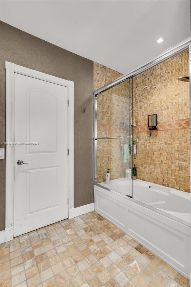 bathroom featuring enclosed tub / shower combo and tile patterned floors