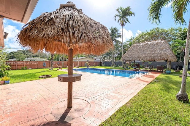 view of pool with a patio area, a gazebo, and a lawn