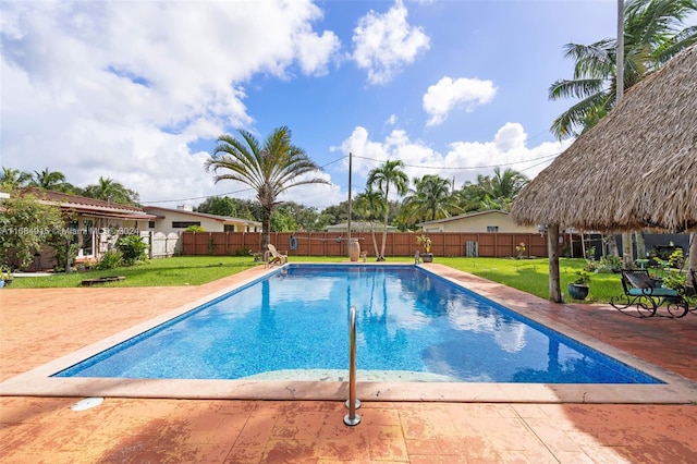 view of pool featuring a yard and a patio area