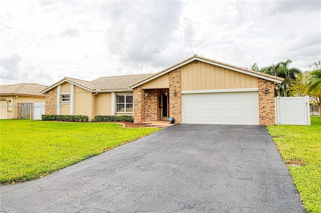 ranch-style house with a front yard and a garage