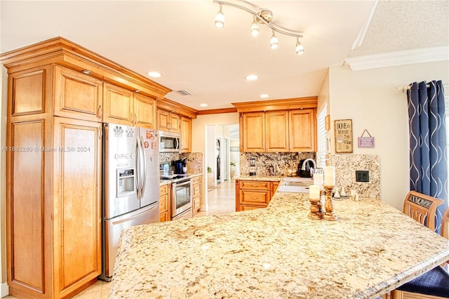 kitchen featuring appliances with stainless steel finishes, backsplash, kitchen peninsula, crown molding, and a breakfast bar area