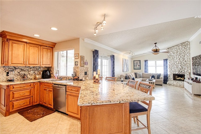 kitchen featuring sink, tasteful backsplash, stainless steel dishwasher, ornamental molding, and light stone countertops