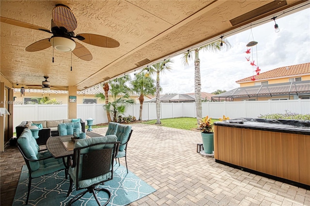 view of patio with a hot tub and ceiling fan