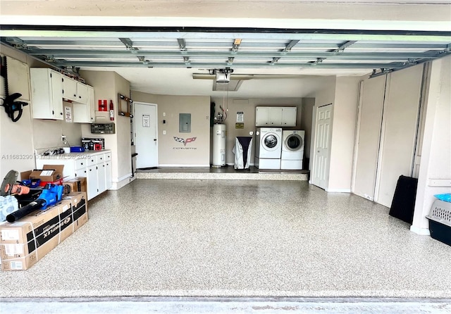 garage with electric water heater, electric panel, and independent washer and dryer