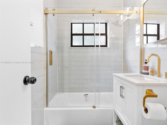 bathroom featuring vanity and shower / bath combination with glass door