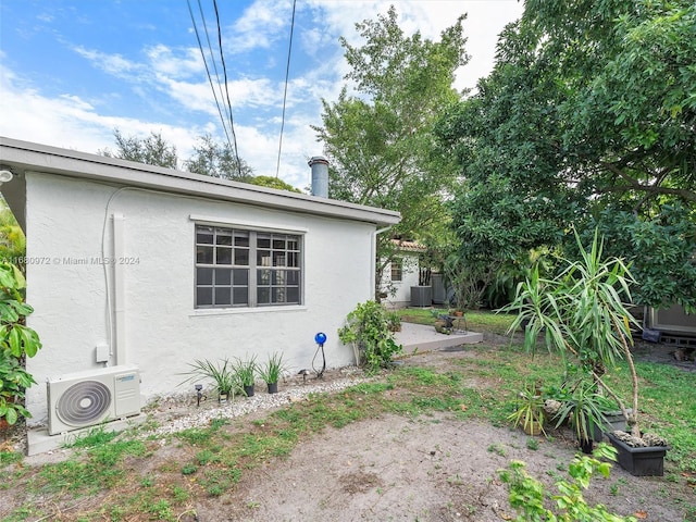 view of side of home featuring ac unit and a patio area