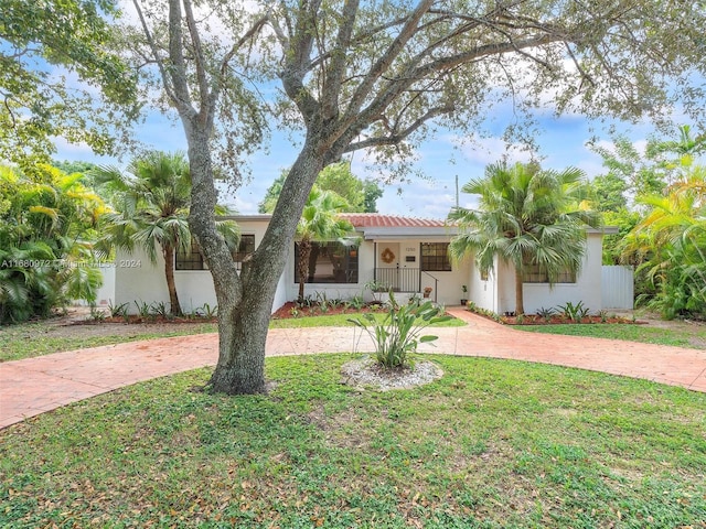 view of front of property with covered porch and a front yard