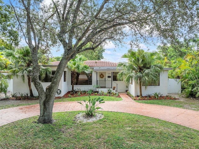 view of front facade with a front yard and a porch