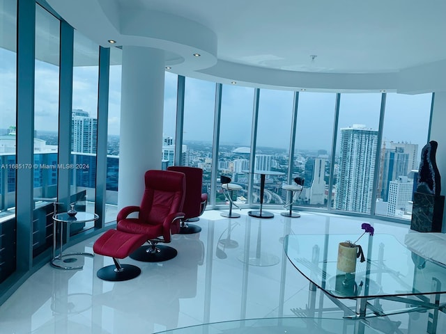 living room with floor to ceiling windows and tile patterned flooring