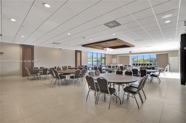 tiled dining space with a wealth of natural light and a tray ceiling