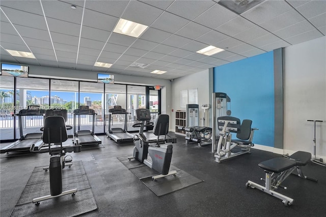 gym with a paneled ceiling