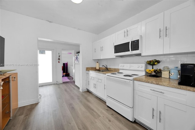 kitchen with decorative backsplash, white cabinets, white appliances, and light hardwood / wood-style floors