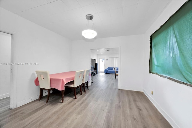 dining space with light hardwood / wood-style flooring