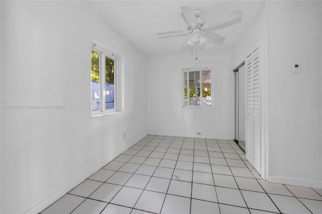 unfurnished room with light tile patterned flooring and ceiling fan