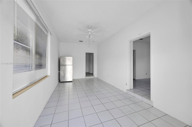 empty room featuring ceiling fan and light tile patterned floors