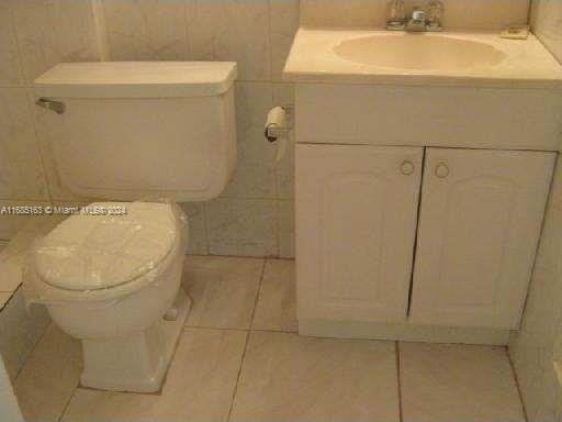 bathroom featuring vanity, toilet, and tile patterned floors