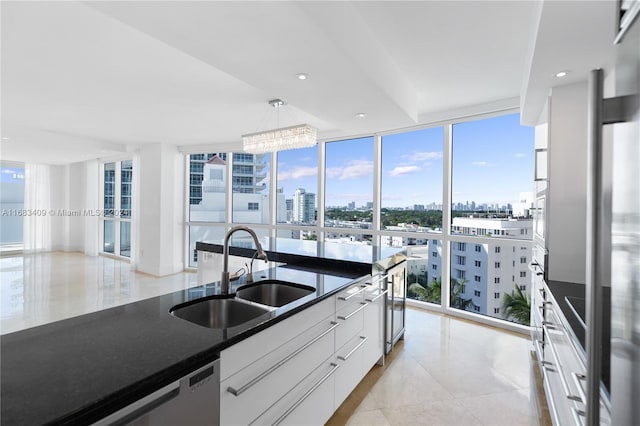 kitchen with sink, a healthy amount of sunlight, and white cabinets