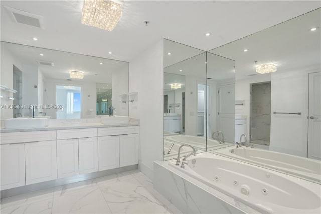 bathroom featuring vanity, a chandelier, and plus walk in shower