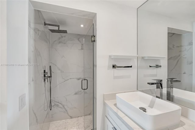 bathroom featuring vanity and an enclosed shower