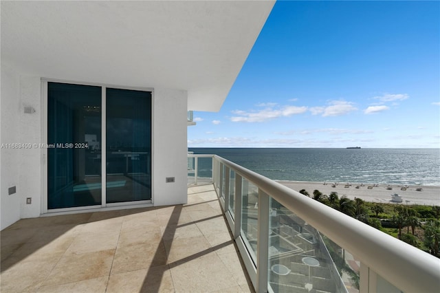 balcony with a water view and a beach view