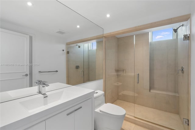 bathroom featuring toilet, vanity, an enclosed shower, and tile patterned flooring