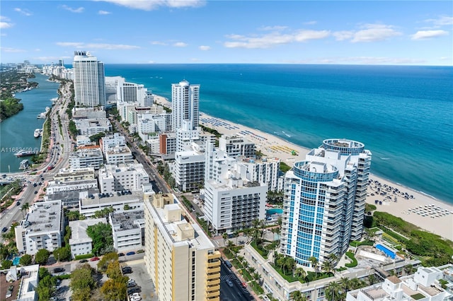 bird's eye view featuring a water view and a beach view