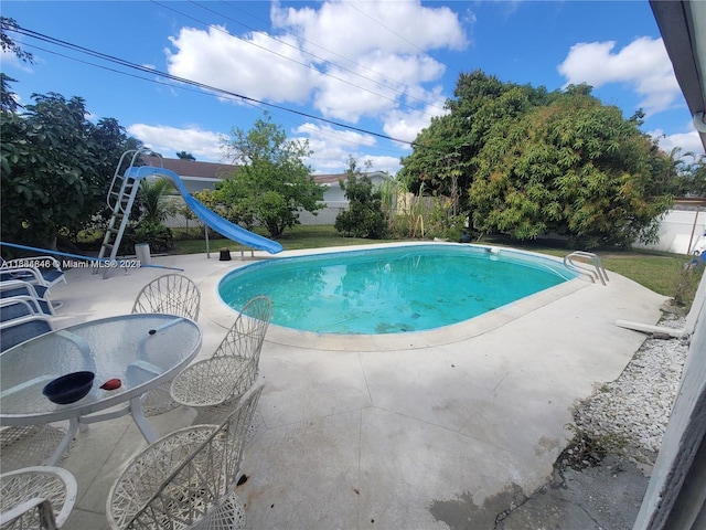 view of pool with a patio area and a water slide