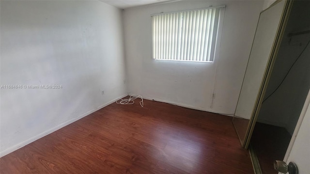 unfurnished room featuring dark hardwood / wood-style floors