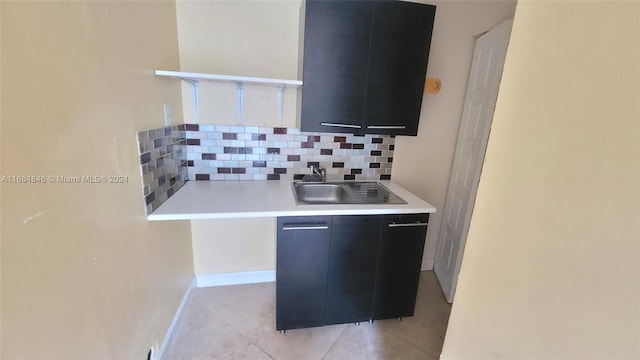 kitchen featuring backsplash, sink, and light tile patterned floors