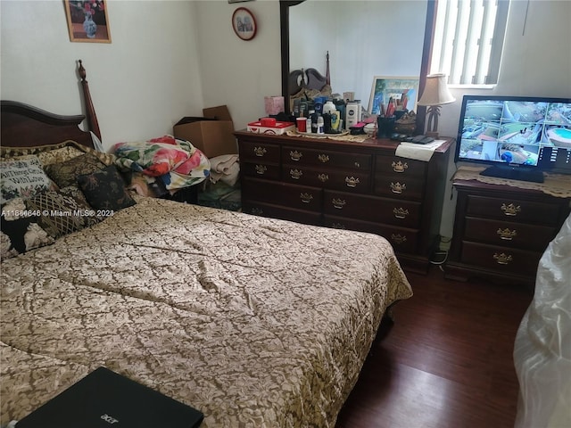 bedroom with dark wood-type flooring