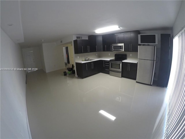 9367 Fontainebleau Blvd Unit G120, Miami, FL 33172 - kitchen with appliances with stainless steel finishes, dark cabinets, light countertops, and a sink