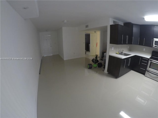 9367 Fontainebleau Blvd Unit G120, Miami, FL 33172 - kitchen with stainless steel appliances, dark cabinetry, light countertops, and a sink