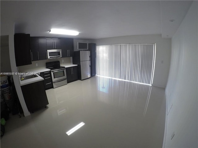 9367 Fontainebleau Blvd Unit G120, Miami, FL 33172 - kitchen with appliances with stainless steel finishes, dark cabinetry, light countertops, and a sink