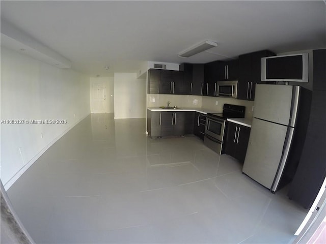 9367 Fontainebleau Blvd Unit G120, Miami, FL 33172 - kitchen with appliances with stainless steel finishes, light tile patterned flooring, light countertops, dark cabinetry, and a sink