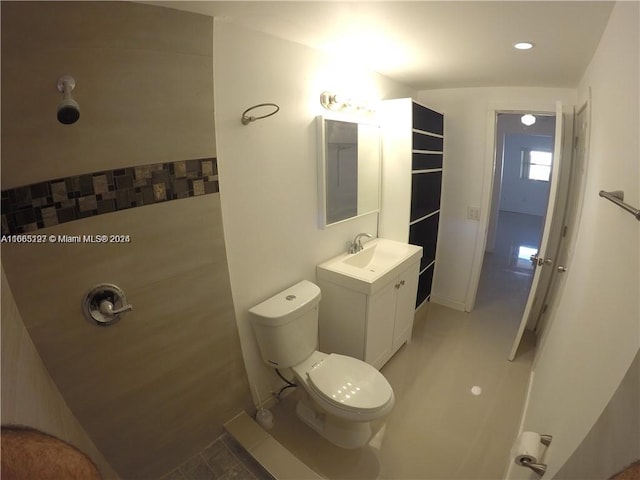 bathroom featuring vanity, toilet, and tile patterned flooring