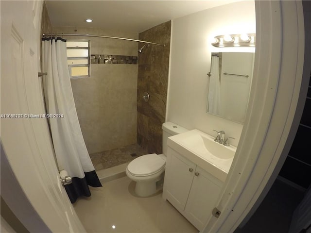 bathroom featuring vanity, a shower with shower curtain, and toilet