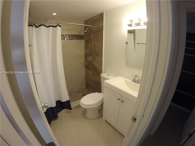 bathroom featuring vanity, curtained shower, and toilet