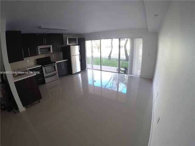 9367 Fontainebleau Blvd Unit G120, Miami, FL 33172 - kitchen with appliances with stainless steel finishes, dark cabinets, light tile patterned flooring, and light countertops