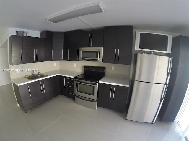 9367 Fontainebleau Blvd Unit G120, Miami, FL 33172 - kitchen featuring stainless steel appliances, light countertops, a sink, and dark cabinetry
