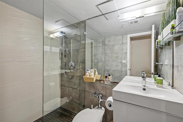 bathroom featuring tile walls, vanity, and a tile shower