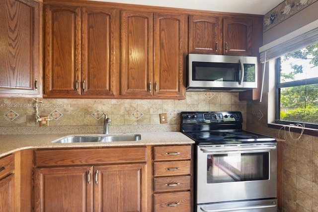 kitchen with decorative backsplash, stainless steel appliances, and sink